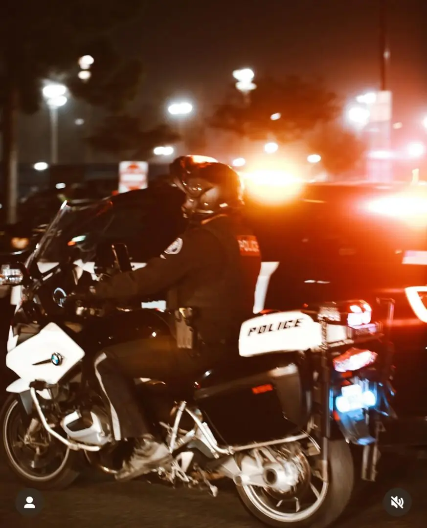 Police officer on motorcycle with flashing lights